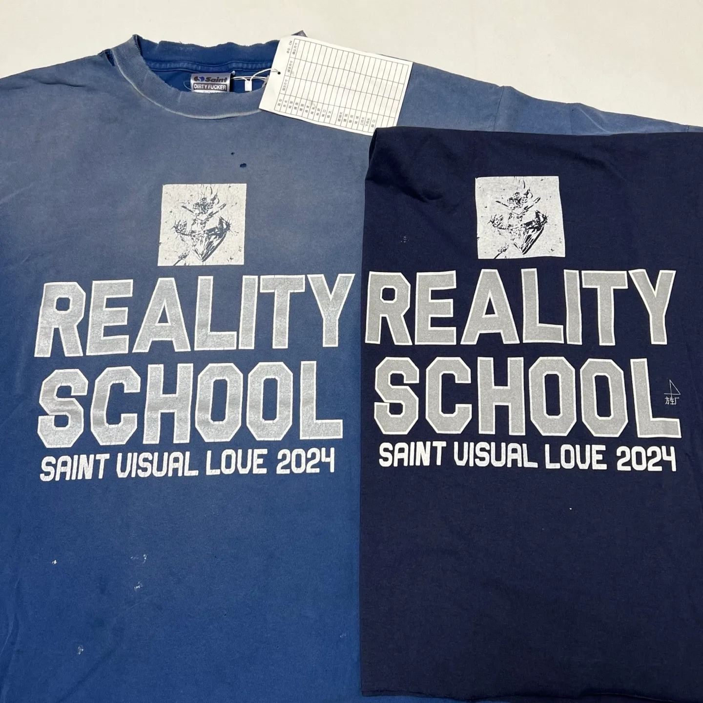 Printing proofing SAINT Mxxxxxx REALITY SCHOOL SS_TEE/NVY Slogan distressed short-sleeves Washed blue S-XL Garment dyeing Ma Liu fading Super complex shearing and destruction treatment Correct version Cylindrical fabric Customized original consistent main mark/wash mark Original consistent silver powder printing Distressed treatment